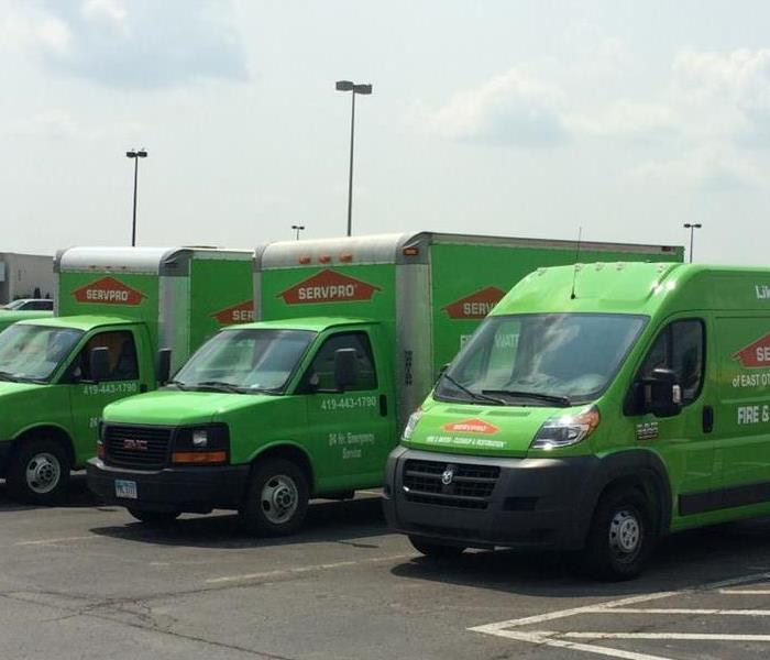 three green SERVPRO trucks