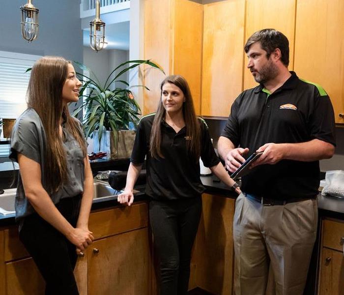 SERVPRO employees talking with home owner 